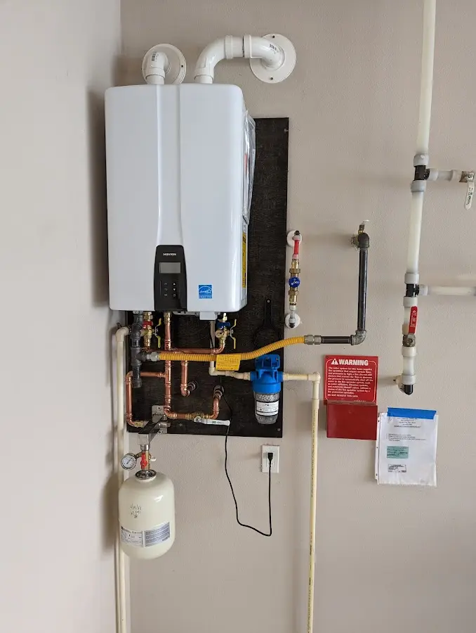 Professional plumber installing copper piping in a Sandy Oaks home